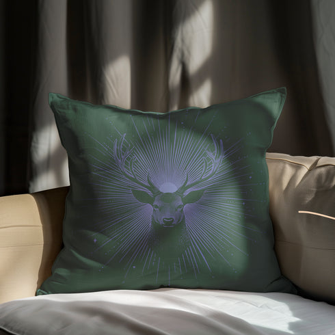 A pillow cover featuring a serene stag's face detailed in soft lavender, surrounded by radiating light beams on forest green fabric. Tiny stars twinkle throughout the design.